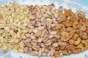 Different dried fruits and nuts on white background, top view. Space for text photo