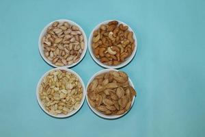 Different dried fruits and nuts on white background, top view. Space for text photo