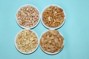 Different dried fruits and nuts on white background, top view. Space for text photo
