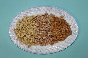 Different dried fruits and nuts on white background, top view. Space for text photo