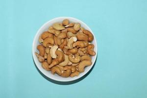 Different dried fruits and nuts on white background, top view. Space for text photo