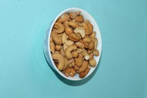 Different dried fruits and nuts on white background, top view. Space for text photo