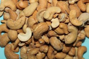 Different dried fruits and nuts on white background, top view. Space for text photo