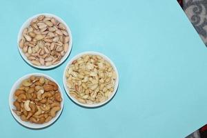 Different dried fruits and nuts on white background, top view. Space for text photo