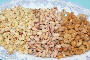 Different dried fruits and nuts on white background, top view. Space for text photo