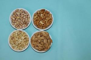 Different dried fruits and nuts on white background, top view. Space for text photo
