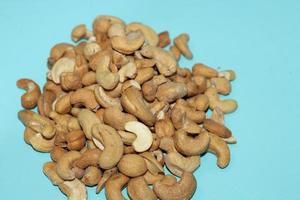 Different dried fruits and nuts on white background, top view. Space for text photo