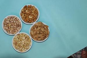 Different dried fruits and nuts on white background, top view. Space for text photo