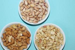 Different dried fruits and nuts on white background, top view. Space for text photo