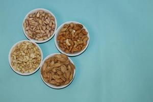 Different dried fruits and nuts on white background, top view. Space for text photo