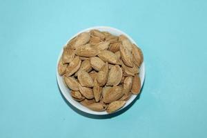 Different dried fruits and nuts on white background, top view. Space for text photo