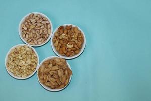 Different dried fruits and nuts on white background, top view. Space for text photo