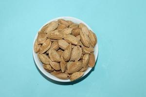 Different dried fruits and nuts on white background, top view. Space for text photo