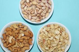 Different dried fruits and nuts on white background, top view. Space for text photo