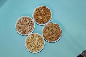 Different dried fruits and nuts on white background, top view. Space for text photo