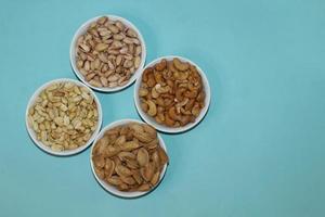 Different dried fruits and nuts on white background, top view. Space for text photo