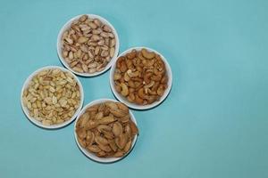 Different dried fruits and nuts on white background, top view. Space for text photo