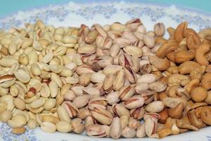 Different dried fruits and nuts on white background, top view. Space for text photo