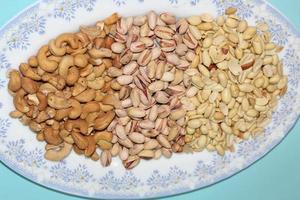 Different dried fruits and nuts on white background, top view. Space for text photo