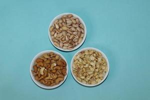 Different dried fruits and nuts on white background, top view. Space for text photo
