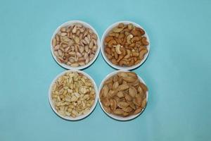 Different dried fruits and nuts on white background, top view. Space for text photo