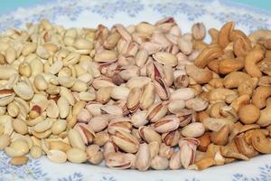 Different dried fruits and nuts on white background, top view. Space for text photo