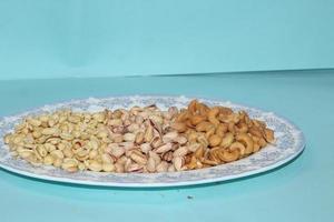 Different dried fruits and nuts on white background, top view. Space for text photo