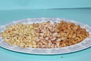 Different dried fruits and nuts on white background, top view. Space for text photo