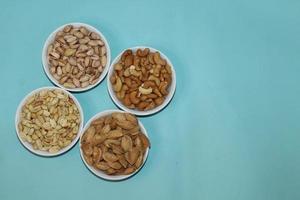 Different dried fruits and nuts on white background, top view. Space for text photo