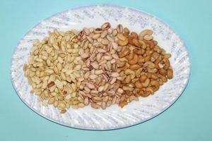 Different dried fruits and nuts on white background, top view. Space for text photo