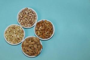 Different dried fruits and nuts on white background, top view. Space for text photo