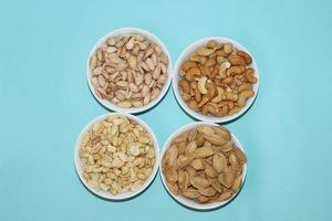 Different dried fruits and nuts on white background, top view. Space for text photo