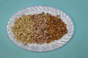 Different dried fruits and nuts on white background, top view. Space for text photo