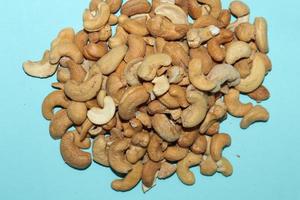Different dried fruits and nuts on white background, top view. Space for text photo