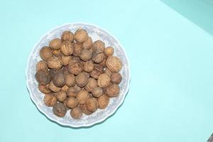 Different dried fruits and nuts on white background, top view. Space for text photo