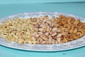 Different dried fruits and nuts on white background, top view. Space for text photo