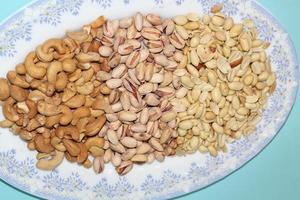 Different dried fruits and nuts on white background, top view. Space for text photo