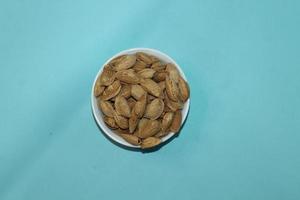 Different dried fruits and nuts on white background, top view. Space for text photo