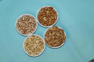 Different dried fruits and nuts on white background, top view. Space for text photo