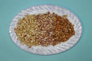 Different dried fruits and nuts on white background, top view. Space for text photo