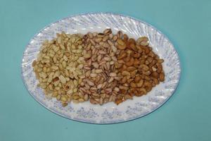 Different dried fruits and nuts on white background, top view. Space for text photo