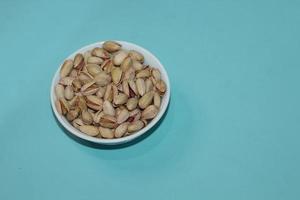 Different dried fruits and nuts on white background, top view. Space for text photo