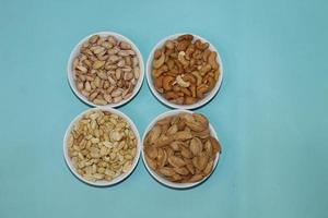 Different dried fruits and nuts on white background, top view. Space for text photo