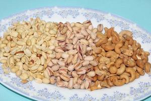 Different dried fruits and nuts on white background, top view. Space for text photo