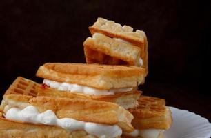 Fresh Viennese waffles with white cream. photo