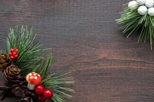 Wooden Christmas frame of spruce, red and green with pinecones of wooden background. Copy space of Christmas and New Year. photo