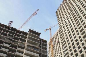 Crane and building construction site. Industry modern new civil house business. Concept of development improvement town. Architecture planning of a city. Renovation project. Residential area photo