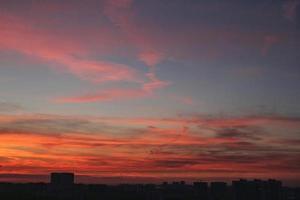 Colorful cloudy twilight beautiful sky cityscape sunset and morning sunrise. Dramatic evening night early morning view with city buildings silhouette. Panoramic background concept. Copy space for text photo