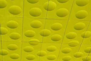 The close-up of yellow detailed sphere texture reverse side of the plastic tile. Rough embossed lattice. Concept of design. Wall decoration interior. Relief balls geometric pattern. Flatlay, mock up photo