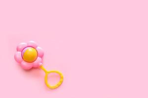 rattle on a pink background with copy space photo